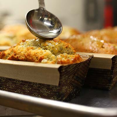 One of our bakers applies a delicate glaze to a signature tea cake.